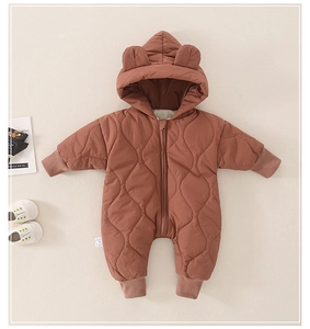 Detail of baby quilted romper with bear ear hood and diamond stitching for winter warmth