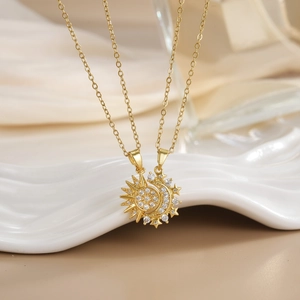 Detailed macro view of gold-plated sun and moon necklaces with white zircon inlays
