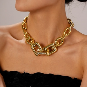 Close-up of chunky gold-tone link chain necklace with polished industrial design