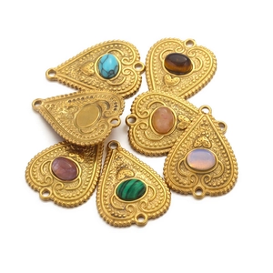 Detailed view of vintage gold heart pendants with colorful semi-precious stones
