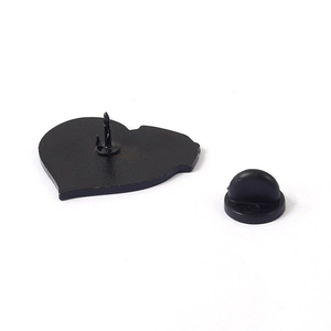 Pink heart-shaped enamel skull brooch with black rubber back pin on white background