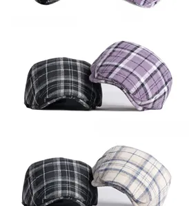 Detailed close-up of plaid wool blend fabric texture on British retro beret caps