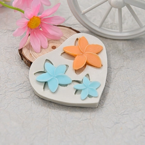 Detailed close-up of heart-shaped silicone mold with three sizes of floral relief patterns