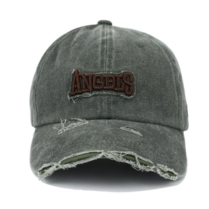 Detail of distressed baseball cap brim with embroidered ANGELS logo and washed texture