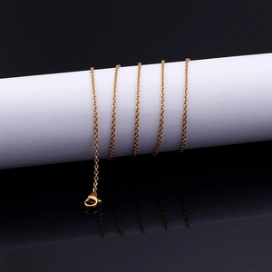 Golden stainless steel cross O-chain necklace with lobster clasp on a black background