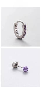 Detail of silver titanium steel earrings set with purple rhinestones and crystal ball studs