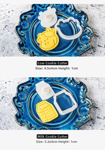 Detailed dimensions of cow and milk box shaped cookie cutters on a blue plate