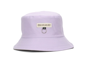 Detail view of purple cotton sun hat featuring letter embroidery and a metal ring accessory