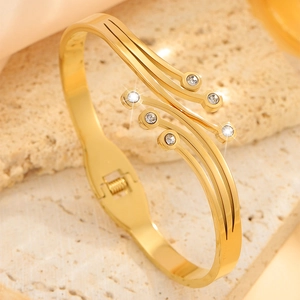 Polished gold titanium steel cuff bracelet with tassel diamond accents and open design