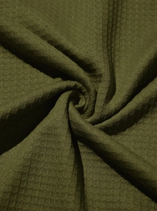 Detailed macro view of dark olive waffle knit fabric texture and soft textile material