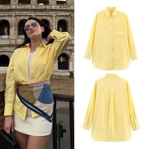 Detailed views of yellow striped button-down shirt featuring collar and pocket design