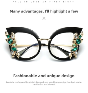 Detail view of cat-eye frames with intricate green crystal leaf rhinestone embellishments