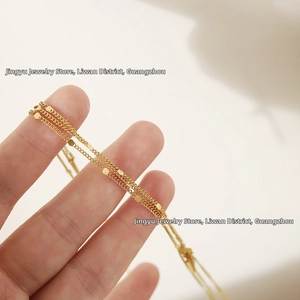 Macro shot of 18K gold plated titanium steel layered bracelet with delicate round sequins