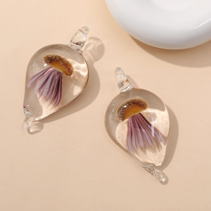 Macro detail of teardrop glass pendants with purple jellyfish-like internal art craft
