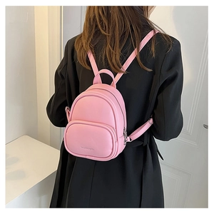 Pink mini PU leather backpack for women shown on model with fashion bags text