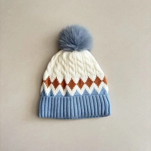 Winter knit hat for toddlers with diamond pattern and large pom pom for outdoor warmth