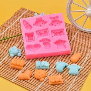 Detail of pink silicone baby mold featuring milk bottle, footprints and boy girl letters