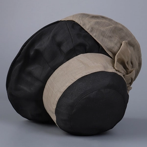 Detail of elegant two-tone linen sun hat with a refined bow and natural woven texture