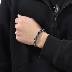 Close-up of a rainbow iridescent metal dragon bone chain bracelet worn on a wrist