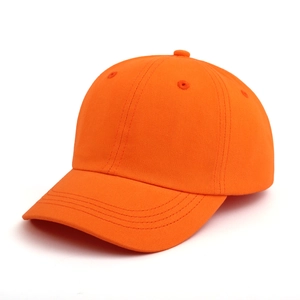 Detail of orange cotton baseball cap showing six-panel structure and breathable eyelets