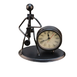 Handcrafted vintage iron desk clock featuring a musician figurine on a pure white background