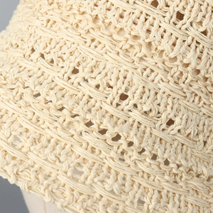 Macro shot of breathable crochet mesh texture on this cream-colored bucket hat