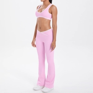 Detailed view of pink yoga set showing cross V-waist flared pants and white contrast edges