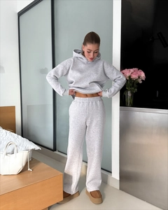 Close-up of cozy grey hooded sweatshirt and matching lounge pants set in a home setting