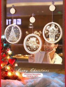 Three LED Christmas suction cup lights with Santa and tree motifs on a window display