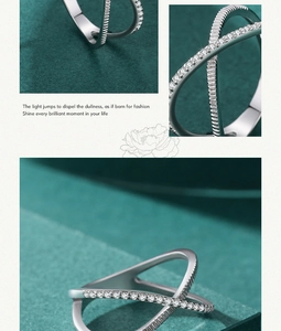 Close-up of S925 sterling silver cross ring with pavé-set zircons on velvet background