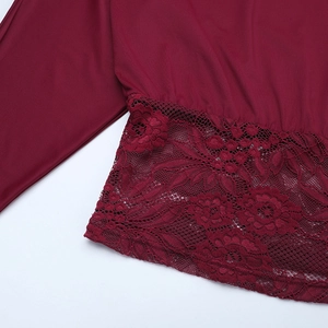 Detail of burgundy lace stitching and smooth fabric on this one-shoulder top
