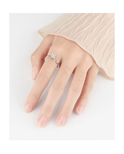Detailed view of silver rotating snowflake ring with zircon star on model finger