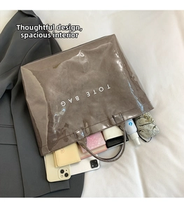 Macro detail showing large capacity of the translucent brown tote bag with daily items