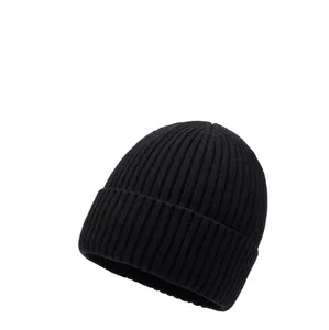 Detailed texture of black knit beanie with mountain emblem for winter warmth