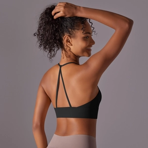 Detail of cross-back straps on black sports bra with high-elastic matte nylon fabric
