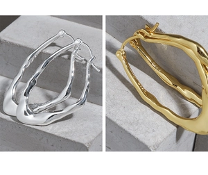 Detail view showing irregular liquid lava texture on S925 sterling silver earrings in gold and silver