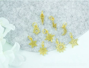 Macro view of assorted 18K gold-plated star and moon charms for DIY jewelry making