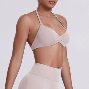 Detailed close-up of seamless dusty pink halter sports bra with ruched chest detail