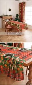 Detail of red and green plaid Christmas tablecloth with holly and pine cone prints