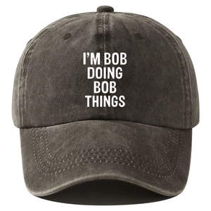 Washed black cotton baseball cap with white I'M BOB DOING BOB THINGS slogan print