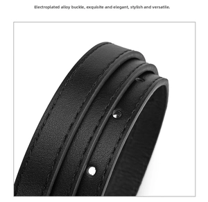 Detail shot of black faux leather belt with reinforced stitching and adjustment holes