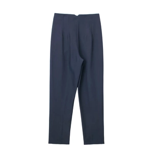 Flat lay of navy blue trousers showing tailored straight-leg cut and smooth fabric