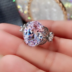 Macro detail of large oval pink zircon ring with elegant butterfly petal silver setting