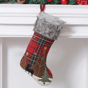 Plaid Christmas stocking with plush faux fur trim and reindeer embroidery hanging on mantle