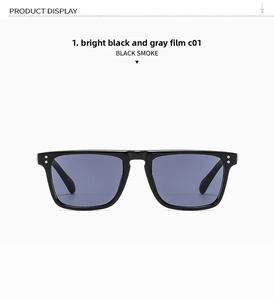 Close-up of classic black square sunglasses with silver rivets and grey tinted lenses