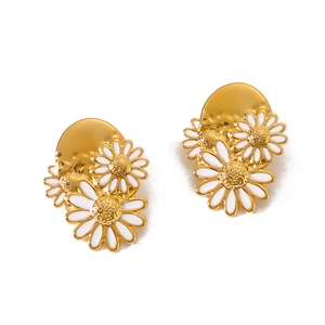 Classic 18k gold plated daisy flower earrings with white petals on a white background