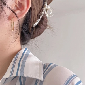Elegant 925 sterling silver Mobius twist stud earrings for women shown on model