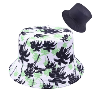 Detail of white graffiti bucket hat with palm tree print and black reversible side