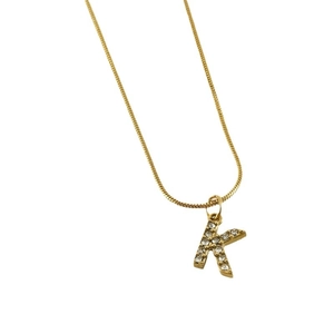 Golden rhinestone-encrusted letter K pendant on a delicate snake chain necklace