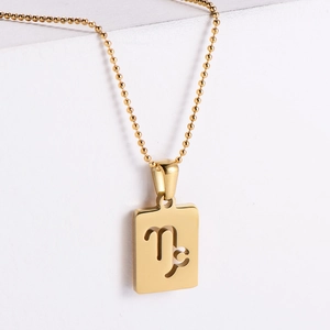 Macro shot of 18k gold plated square pendant with Capricorn constellation cutout detail